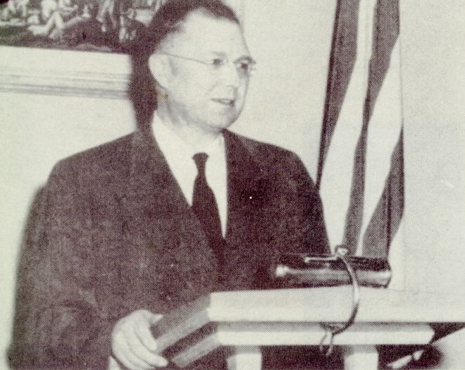 Ambrose Reiter, who served as a Village Trustee (1949-57) and Mayor (1957-61) addresses a voters' group in 1957.